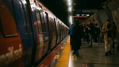 A busy evening with commuters waiting at an Istanbul subway station platform.