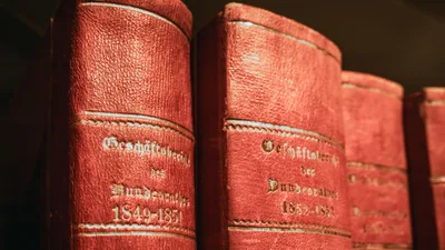 Red leather-bound parliamentary books from 19th century in Bern library, Switzerland.